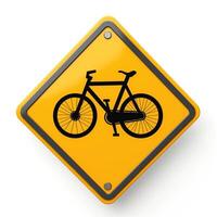 Bicycle warning sign featuring a black icon on a bright yellow background. photo