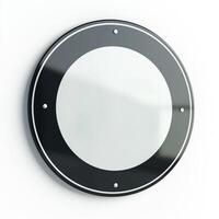 A sleek, modern circular wall mirror with a black frame, reflecting minimalistic design elements. photo