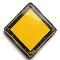 A weathered yellow diamond warning sign with a black border, conveying a sense of caution. photo