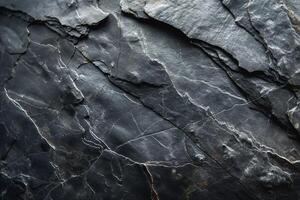 Dark, textured slate rock with intricate patterns and veins, showcasing natural beauty. photo