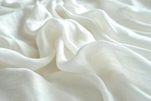 Soft and delicate white fabric draped elegantly, creating gentle waves and textures. photo