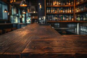 Warm wooden bar surface with a blurred background of shelf filled with various spirits and bottles. photo