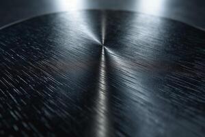 Close-up of a textured metal surface, showcasing intricate patterns and reflections. photo