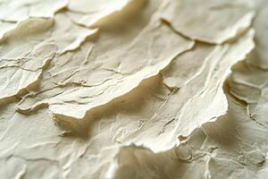Close-up of textured paper showcasing intricate layers and folds, creating a soft, organic aesthetic. photo