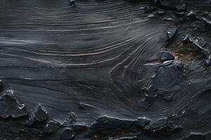 Textured black wood surface with intricate grain patterns, showcasing nature's artistry. photo