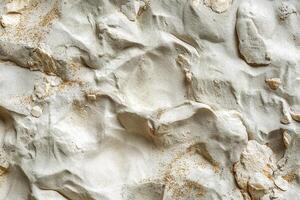 Textured surface of white stone with intricate patterns and natural imperfections. photo