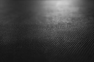 Close-up view of a dark textured surface, highlighting intricate patterns and depth. photo