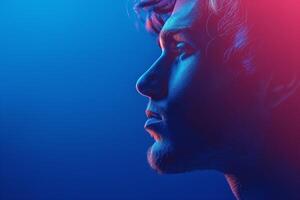 Profile of a young Caucasian male with striking blue and pink lighting, highlighting his features against a vibrant background. photo