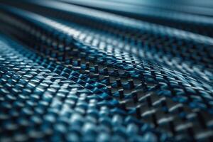 Close-up of a textured blue carbon fiber material, showcasing its intricate patterns and modern allure. photo
