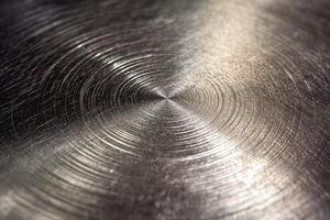 A close-up view of a polished metal surface exhibiting circular patterns. photo