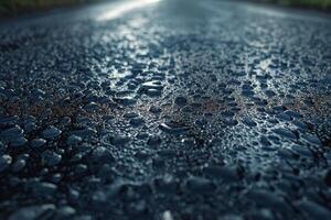 Close-up of water droplets on a dark asphalt road surface after rain. photo