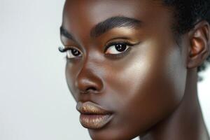 Close-up portrait of a young Black woman exhibiting stunning makeup with bold eyeliner and metallic lip color. photo