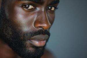 Close-up portrait of a handsome Black man with a strong jawline and intense gaze. photo