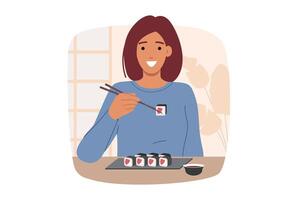 Woman eats maki rolls using chopsticks while sitting at table in oriental japanese restaurant vector