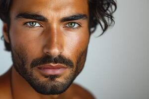 Close-up portrait of a young, muscular Middle-Eastern man with curly hair and striking green eyes. photo
