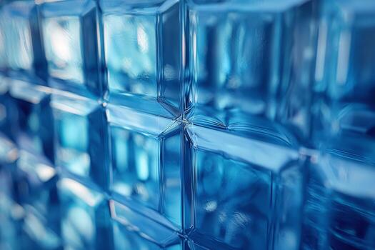 A close-up view of textured blue glass blocks, showcasing the interplay of light and shadow. photo