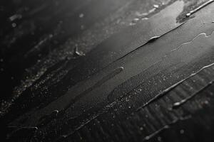 Abstract close-up of smooth black liquid flowing on a textured surface, creating a sleek and modern aesthetic. photo
