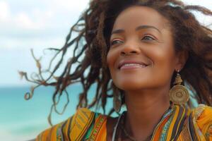 Smiling woman with dreadlocks in colorful attire, enjoying a sunny beach day. photo