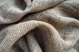 Close-up of textured burlap fabric showcasing its natural fibers and woven patterns. photo