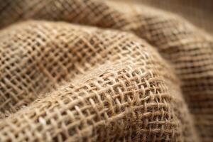 Close-up of a textured jute fabric showcasing its natural fibers and earthy tones. photo