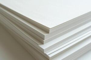 A stack of clean, white sheets of textured paper, showcasing a minimalist aesthetic and perfect for artistic projects. photo