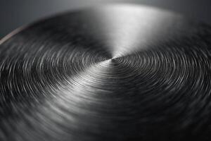 Close-up of a polished metal surface with intricate circular patterns, showcasing a sleek and modern aesthetic. photo