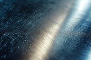 Close-up of brushed metal surface showcasing subtle reflections in cool tones. photo