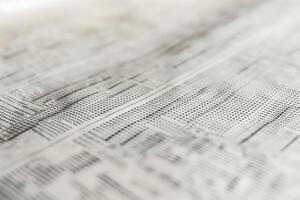 Close-up of a detailed financial document with numerous rows of data and figures, showcasing a monochromatic design. photo