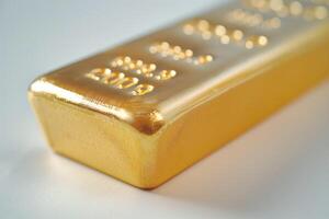 A close-up view of a shiny gold bar, symbolizing wealth and luxury, with intricate details and a warm golden hue. photo