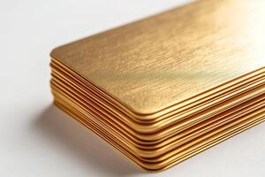 A close-up of neatly stacked, shiny gold-toned metal plates, exuding luxury and elegance. photo