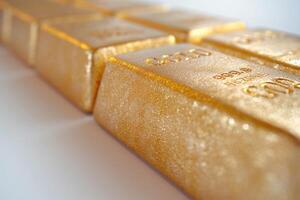 Close-up of shimmering gold bars stacked elegantly, showcasing their luxurious texture and shine. photo