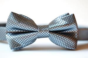 Close-up of a stylish silver checkered bow tie, perfect for formal occasions and adding a touch of elegance to any outfit. photo