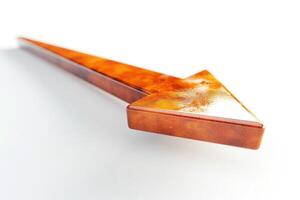 A sleek, glossy brown arrow pointing left on a clean white background, symbolizing direction and movement. photo