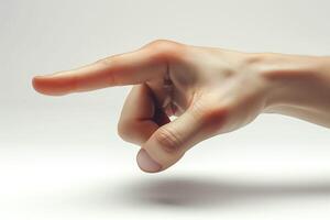 A close-up of a Caucasian male hand pointing with a relaxed posture against a soft, neutral backdrop. photo