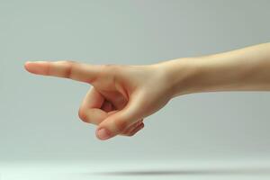 A close-up of a human hand, pointing with a slender index finger against a soft, neutral background. photo