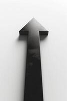 A bold black arrow pointing upward against a minimalistic white background, symbolizing growth and direction. photo
