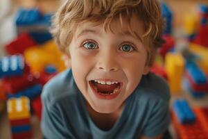 A joyful Caucasian boy playing with colorful building blocks, showcasing his excitement and happiness. photo