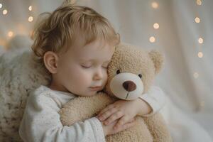 A young Caucasian boy peacefully sleeps while hugging a soft teddy bear, surrounded by warm fairy lights. photo