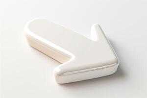 A smooth, glossy white arrow-shaped object on a light gray background, symbolizing direction and movement. photo