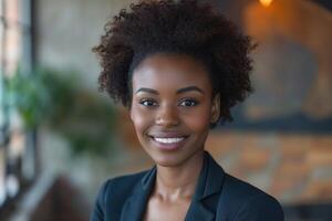Smiling African woman with curly hair in a professional setting, exuding confidence and warmth. photo