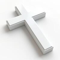 A simple white cross symbolizing faith and spirituality, placed on a clean white surface. photo