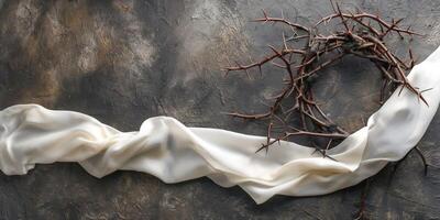 Delicate white satin ribbon flows alongside a rustic crown of thorns, symbolizing contrasts of softness and hardship. photo