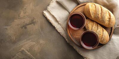 Two glasses of red wine paired with freshly baked bread on a wooden platter, showcasing a warm and inviting atmosphere. photo