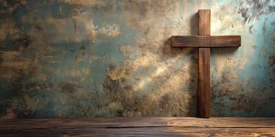 A wooden cross stands alone against a weathered blue wall, symbolizing faith and spirituality in a serene setting. photo