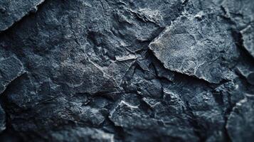 An abstract image of a rock face with intricate texture and shadowy highlights, perfect for backgrounds or textures. photo