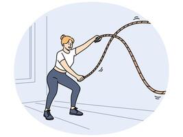Woman doing fitness using battle rope training at sport center to lose weight or build muscles vector