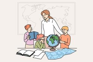 Geography teacher teaches small children using maps and globes or atlases, standing in classroom vector