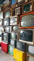 Stacked analog TVs create a tower of obsolete technology photo