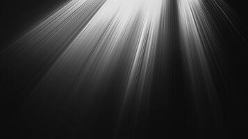 Rays of light breaking through a dark space, creating a dramatic and ethereal atmosphere. The black and white tones enhance the visual impact. photo