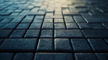A textured surface with square, dark grey tiles arranged in a grid pattern, creating a geometric design with a shallow depth of field. photo